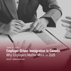 Employer reviewing immigration and employment documents during a business meeting, illustrating employer-driven immigration in Canada and workforce planning strategies for 2026.